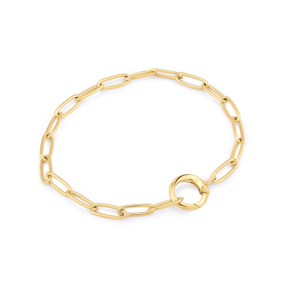 A gold-plated paperclip-link bracelet with a ring able to hold charms