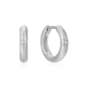 A pair of sterling silver huggie hoop earrings with a single cubic zirconia set in the front of each inside of a star accent
