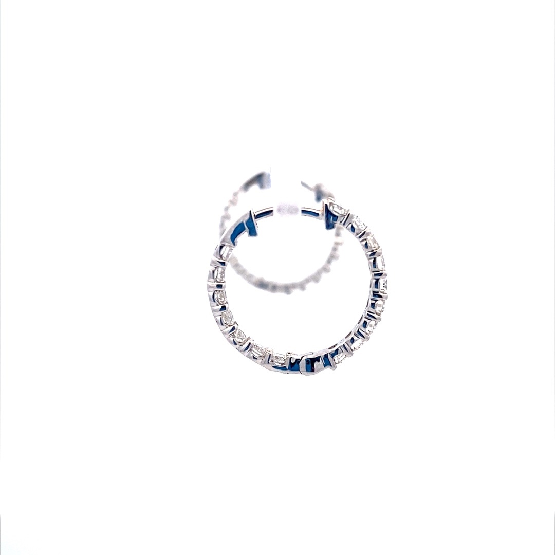 A pair of round-shaped gold diamond hoop earrings