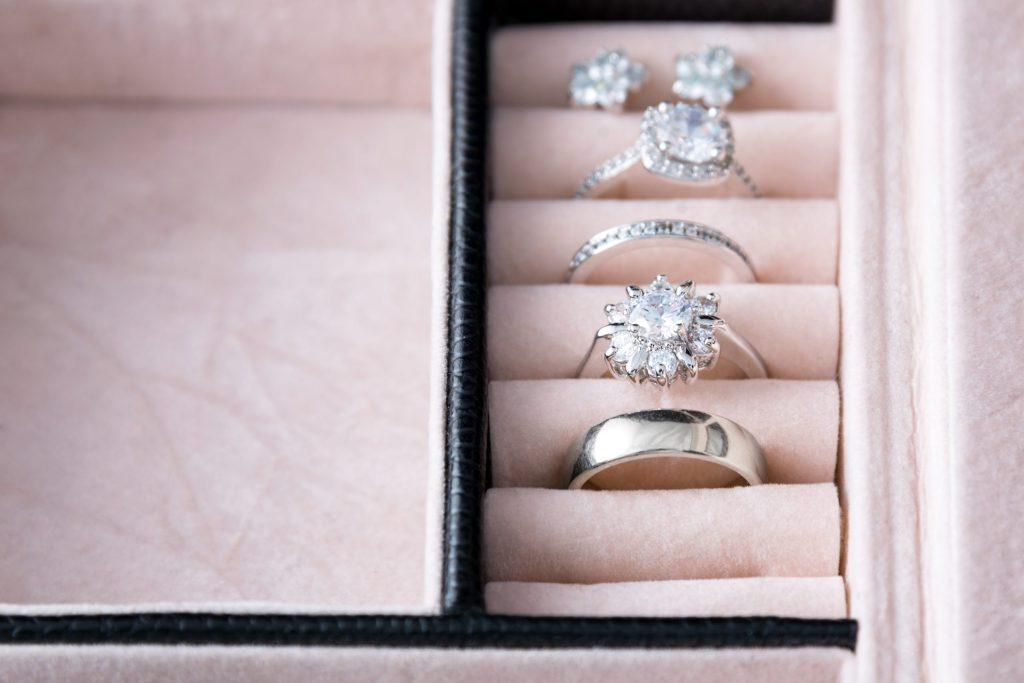 Jewelry box with white gold and silver rings. Collection of luxury jewelry.