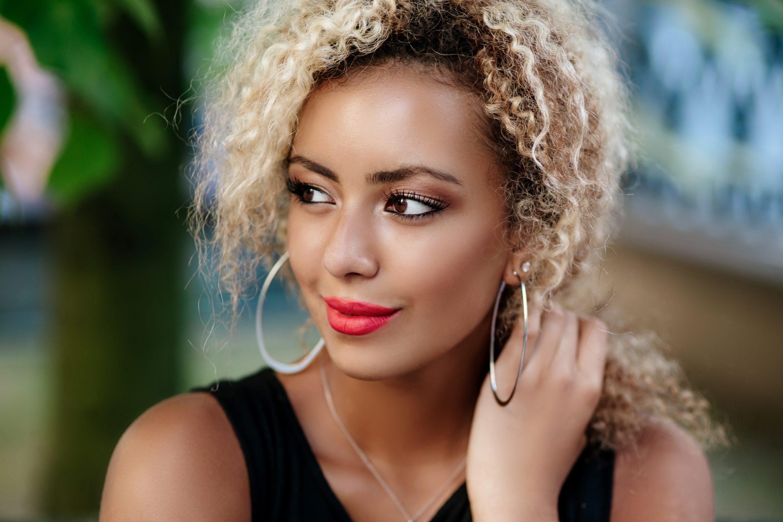 A beautiful young woman smiles as she looks off camera