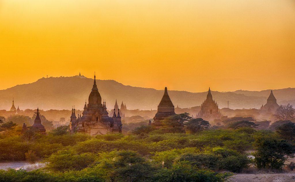 Sun is setting over old Buddhist pagodas of an ancient city of Bagan, Myanmar