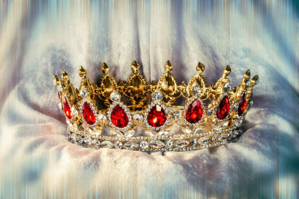 A beautiful crown with rubies on soft clothes with color effect