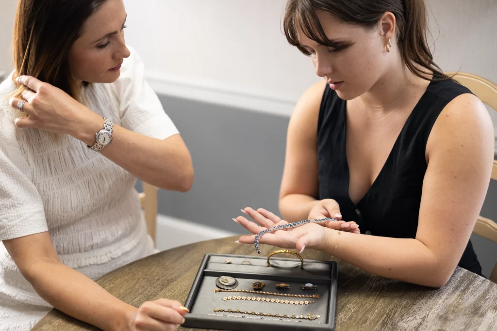 A woman selling her vintage jewelry to another woman