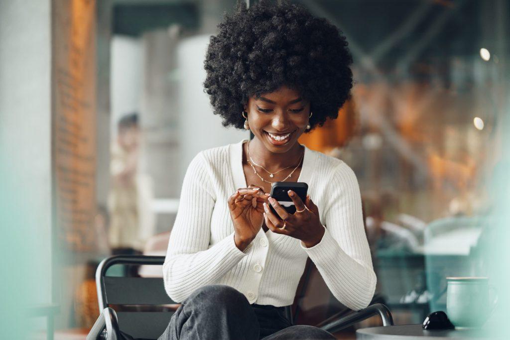 Portrait,Of,A,Beautiful,Young,African,Woman,Using,Her,Cellphone
