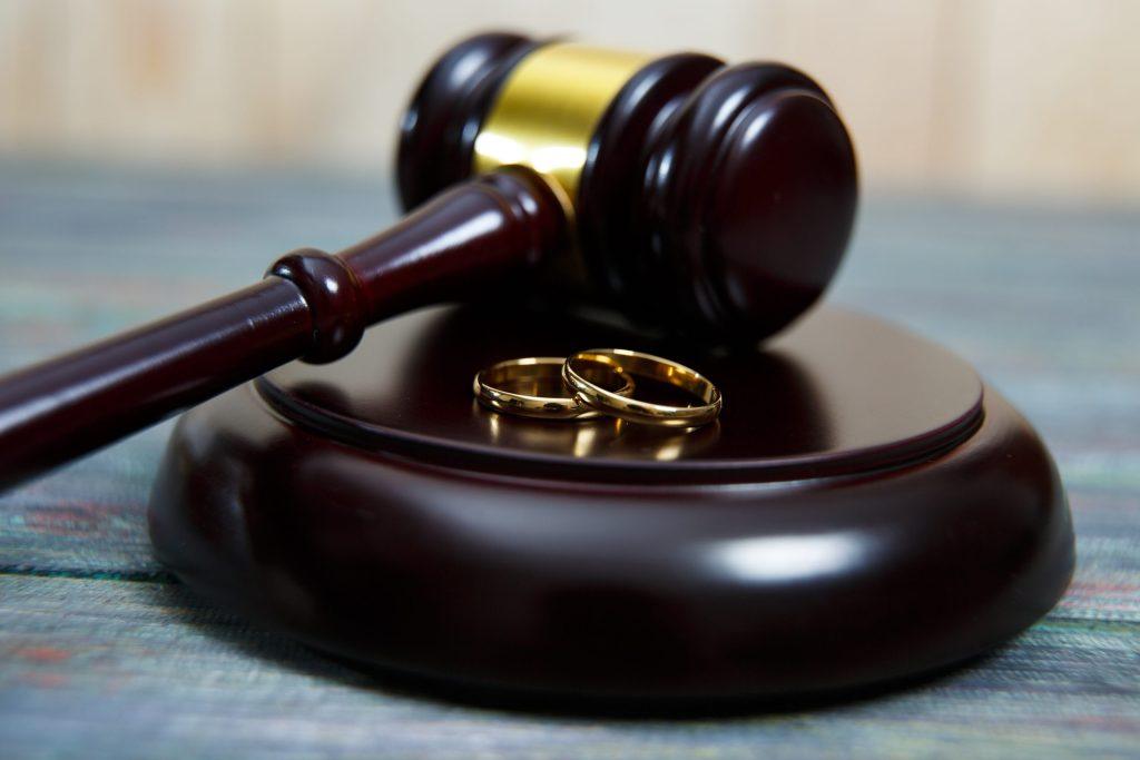 Vintage jewelry auction. A gavel and two gold wedding bands.