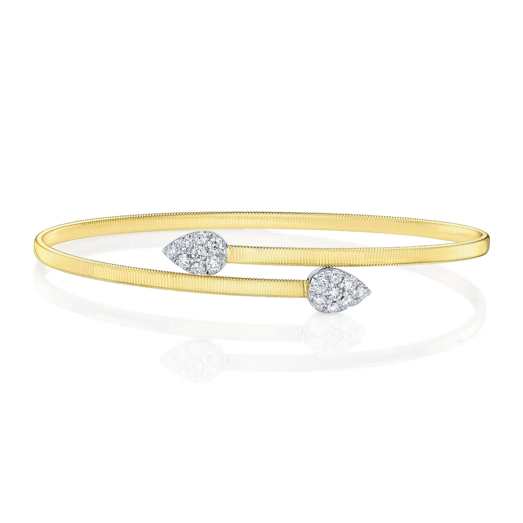 A two-tone gold bypass cuff bracelet containing round-faceted diamonds weighing 0.44 carat total weight in pear-shaped finials