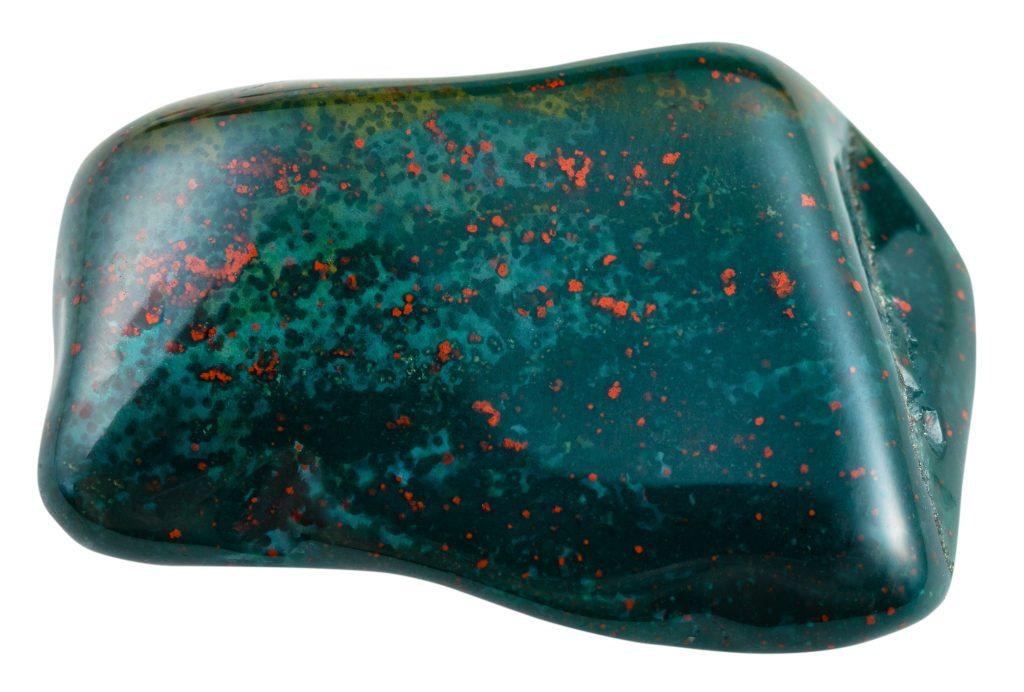 An isolated image of a tumbled bloodstone with a white background