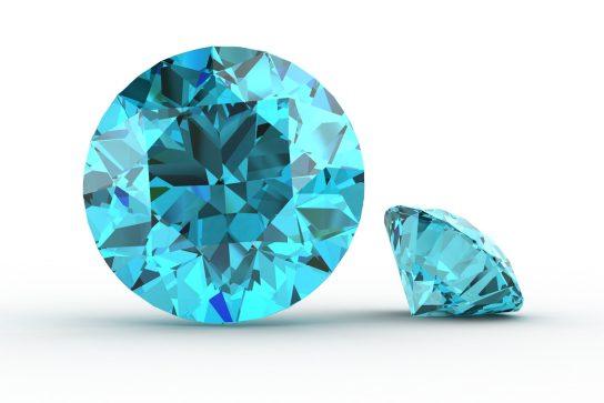 An isolated image of two round-faceted aquamarines with a white background and drop shadow